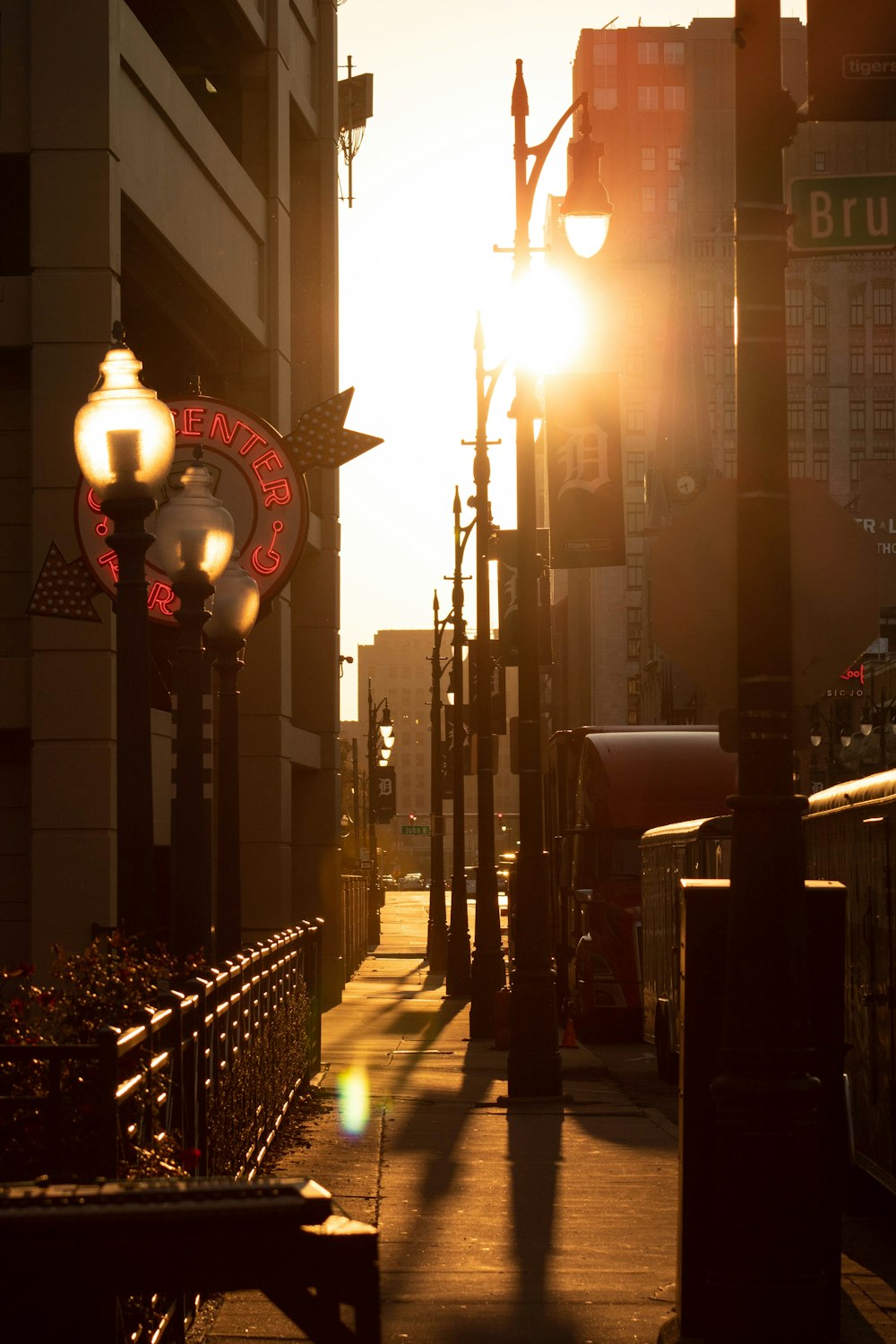 the sun is shining down on a city street
