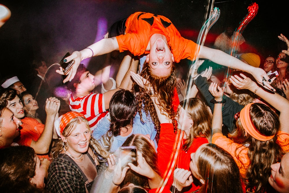 a group of people standing around each other at a party