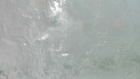 Rippling water with gentle, swirling patterns, creating a dynamic and fluid texture.