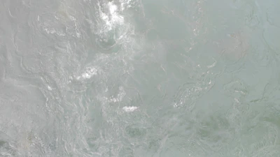 Ripple patterns merging seamlessly with an hourglass outline.