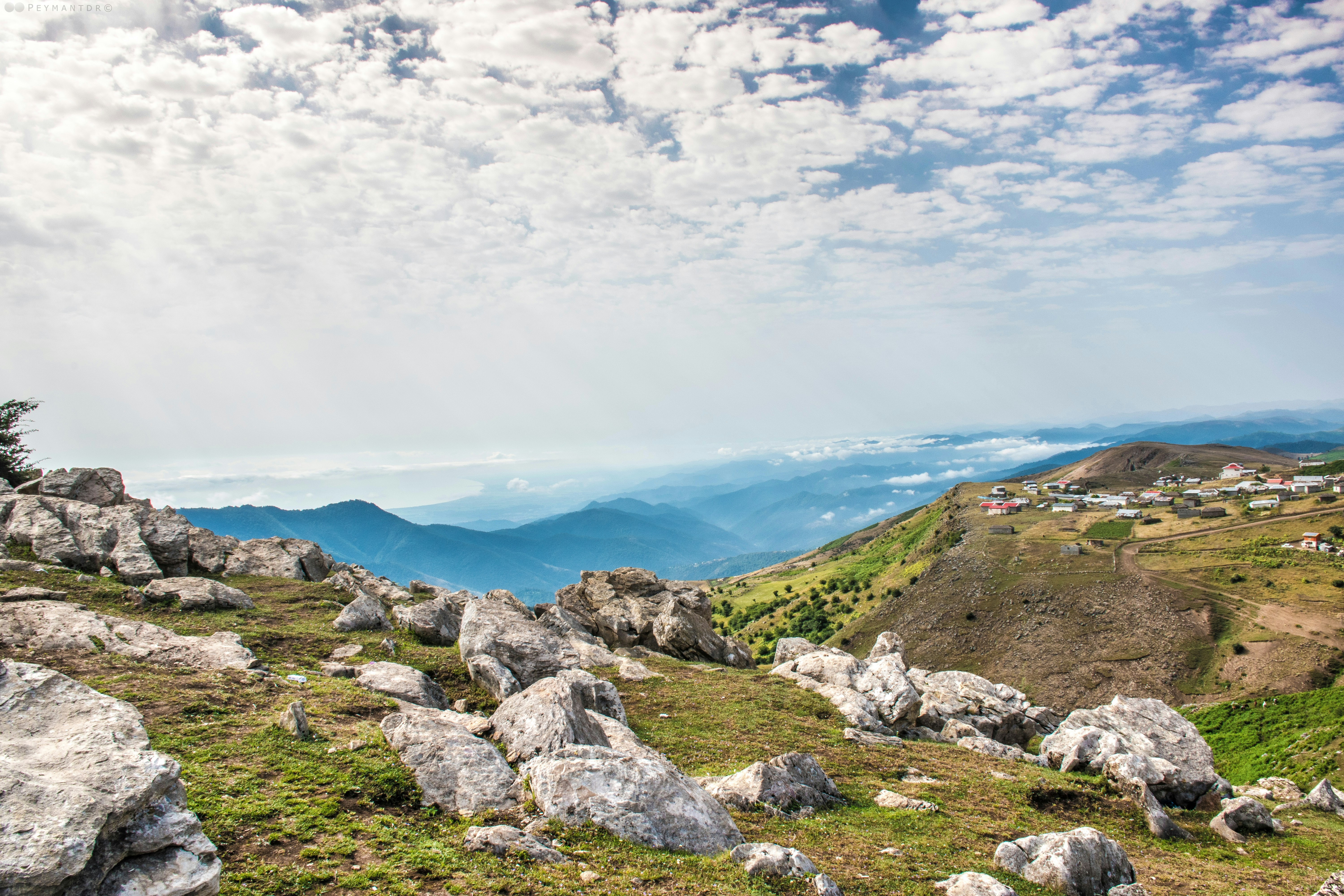 a view of the mountains from the top of a hill
