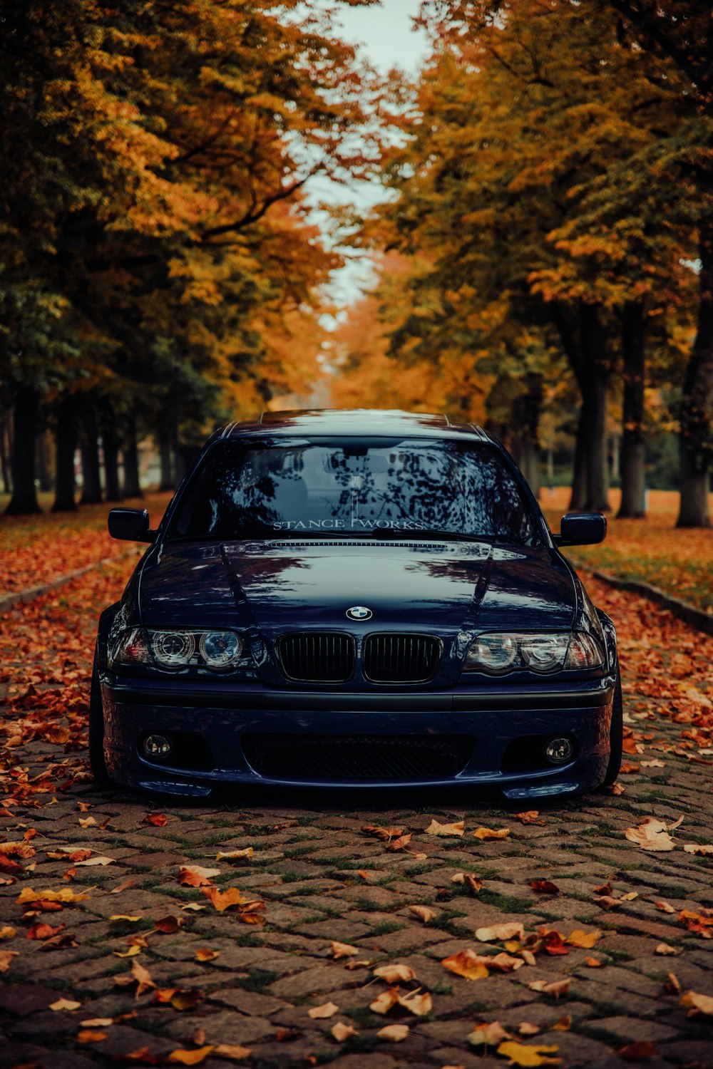 a black car parked on the side of a road