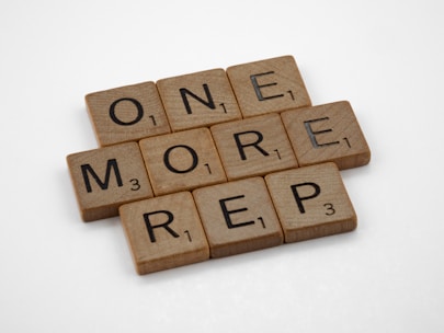 a scrabble of words that spell out one more rep 3
