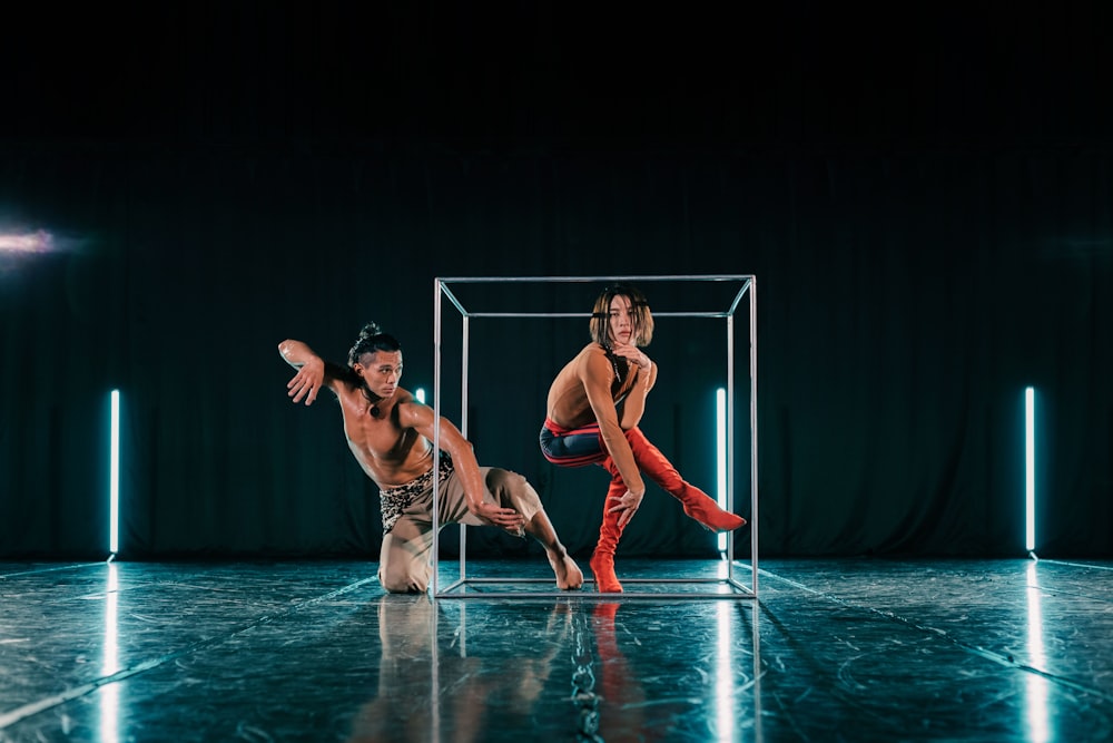 a couple of men standing next to each other on a stage