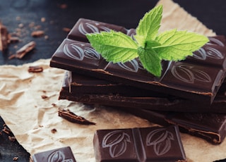 Chocolate pieces on wooden background