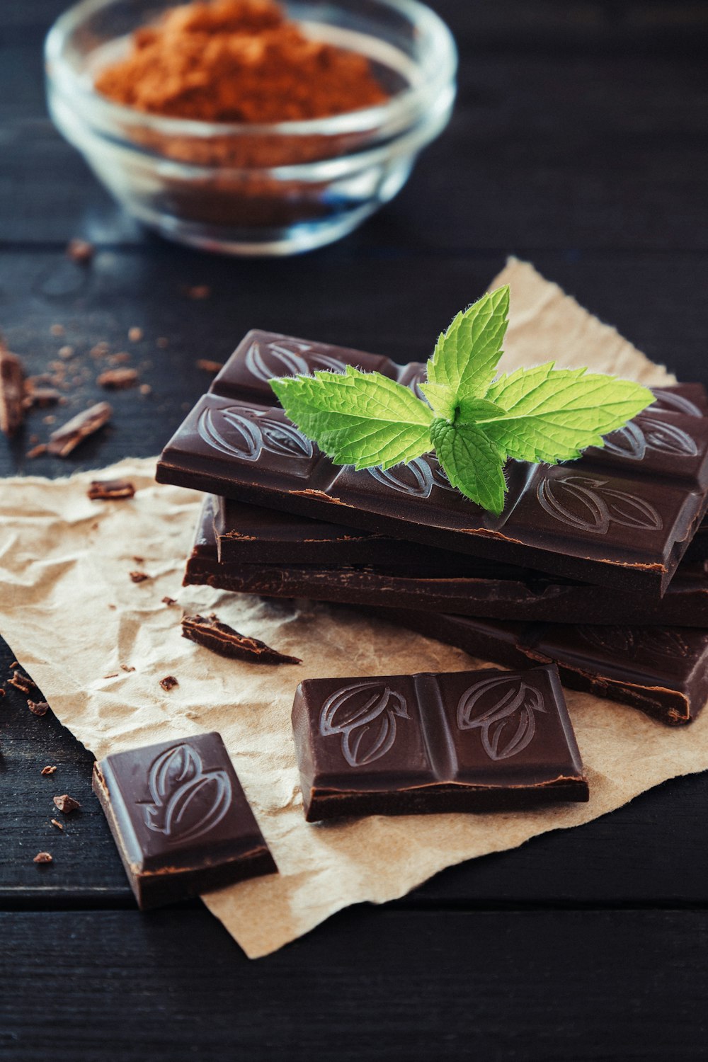 a pile of chocolate with a green leaf on top of it