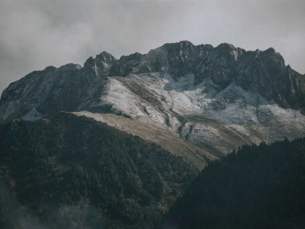 a mountain covered in snow on a cloudy day