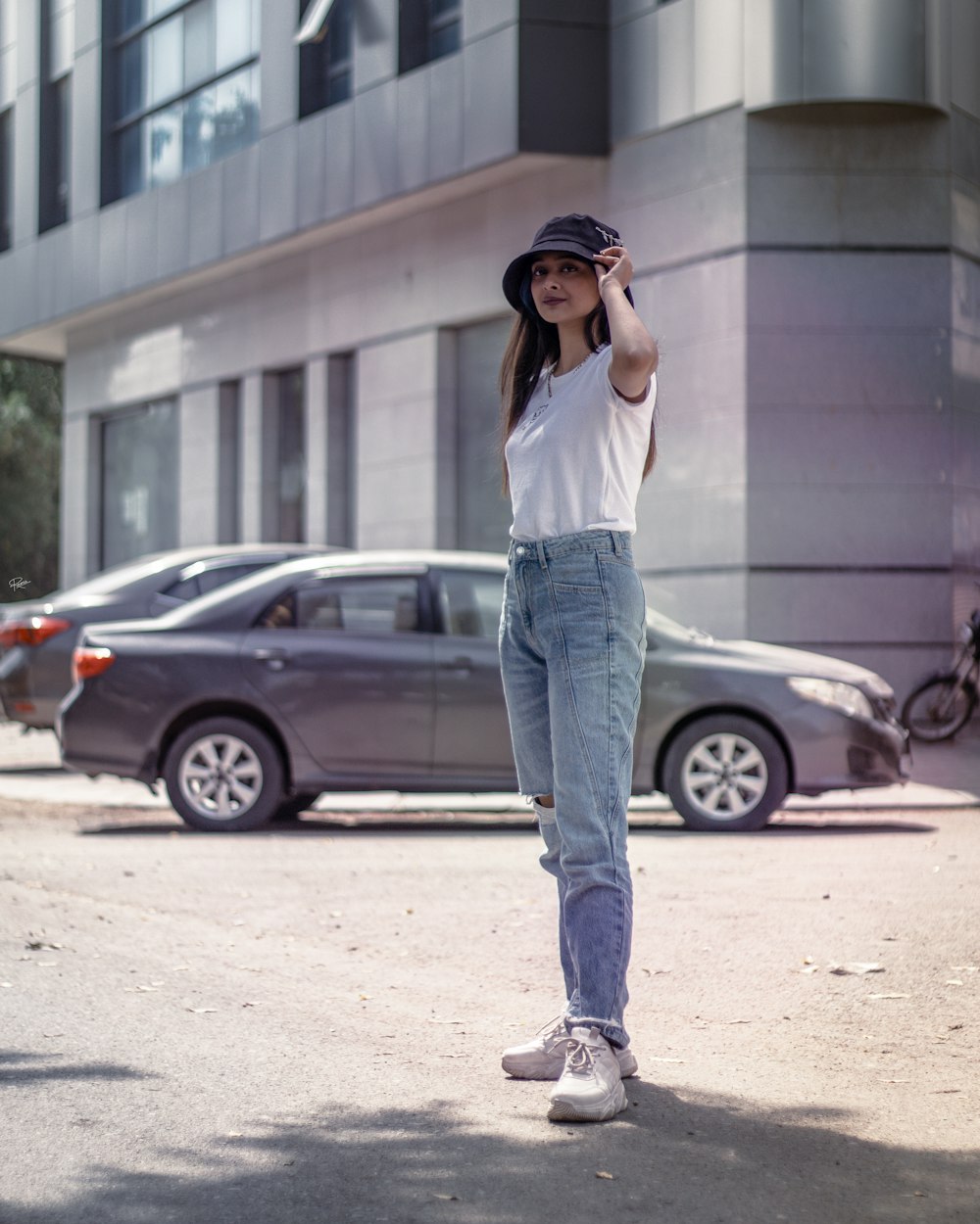 a woman standing on the street talking on a cell phone