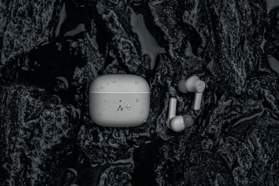 a pair of ear buds sitting on top of a tree