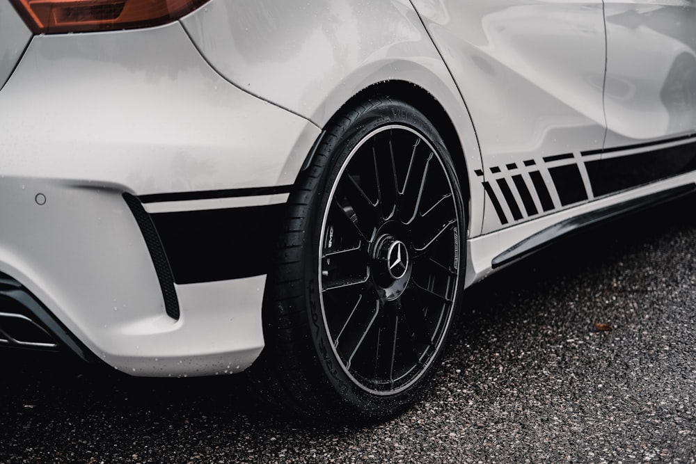 a close up of a white car parked on the street