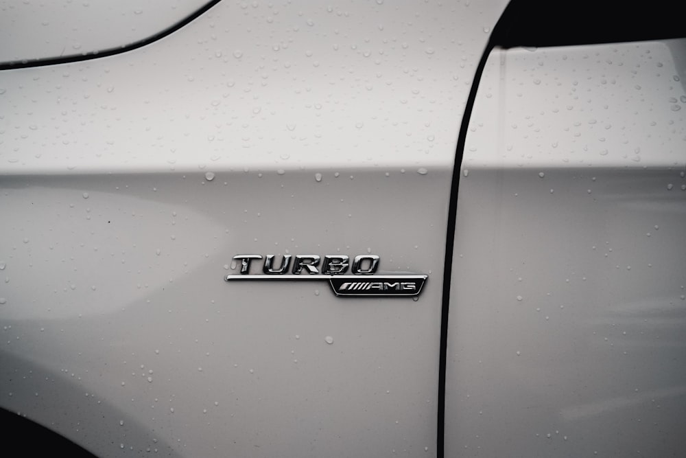 a close up of the emblem on a white car