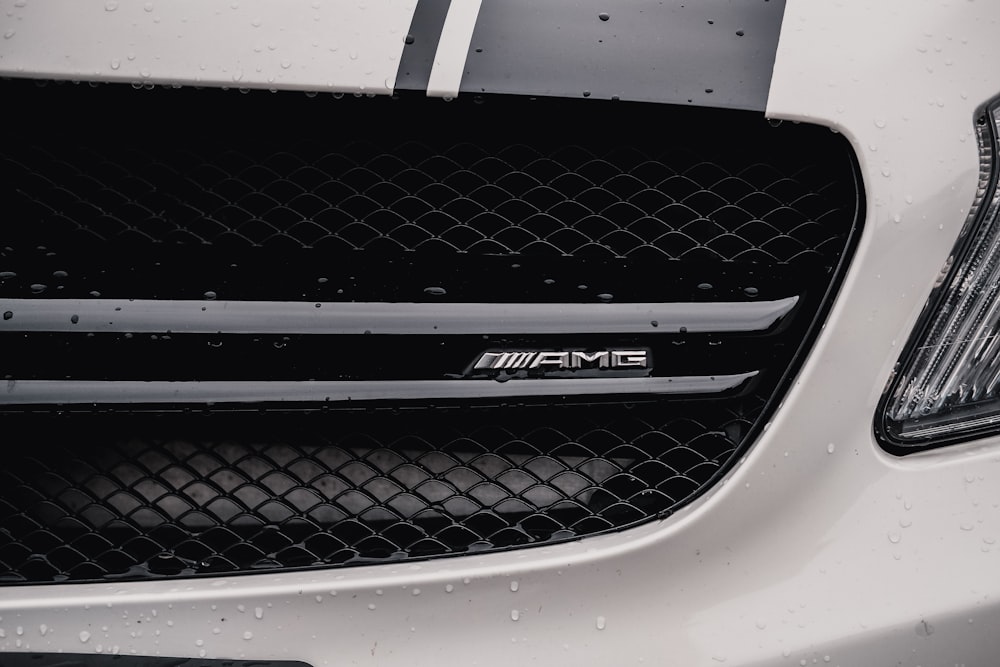 a close up of the hood of a white sports car
