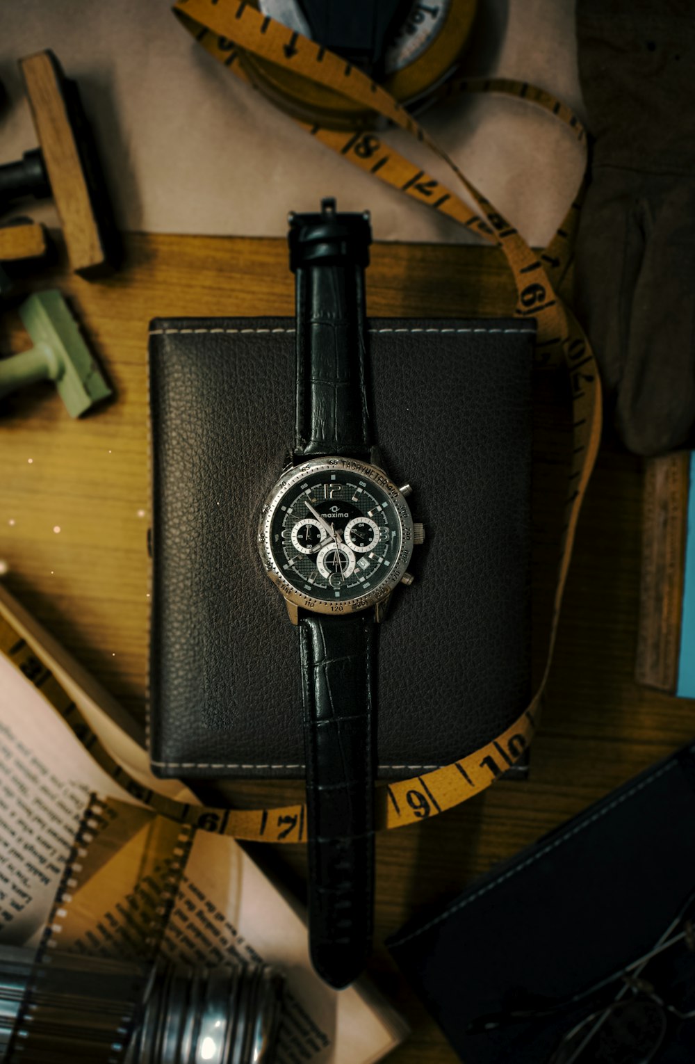 a watch sitting on top of a black leather case