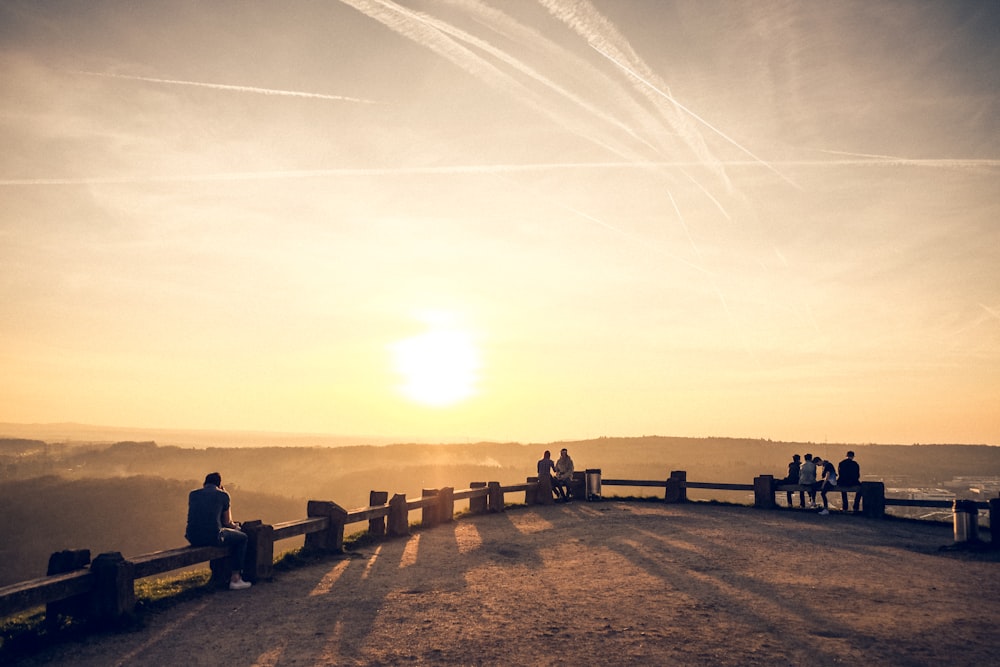 a group of people standing on top of a hill