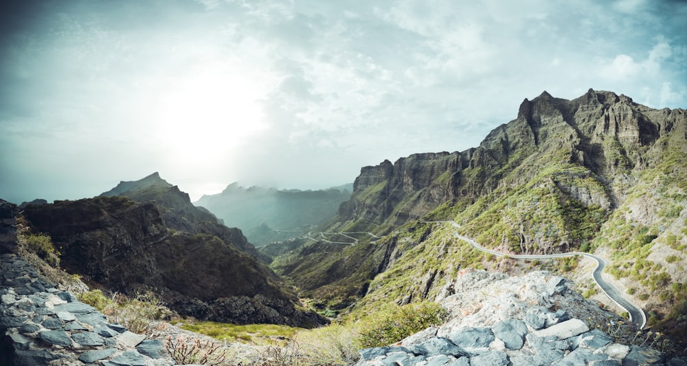 a winding road in the middle of a mountain range