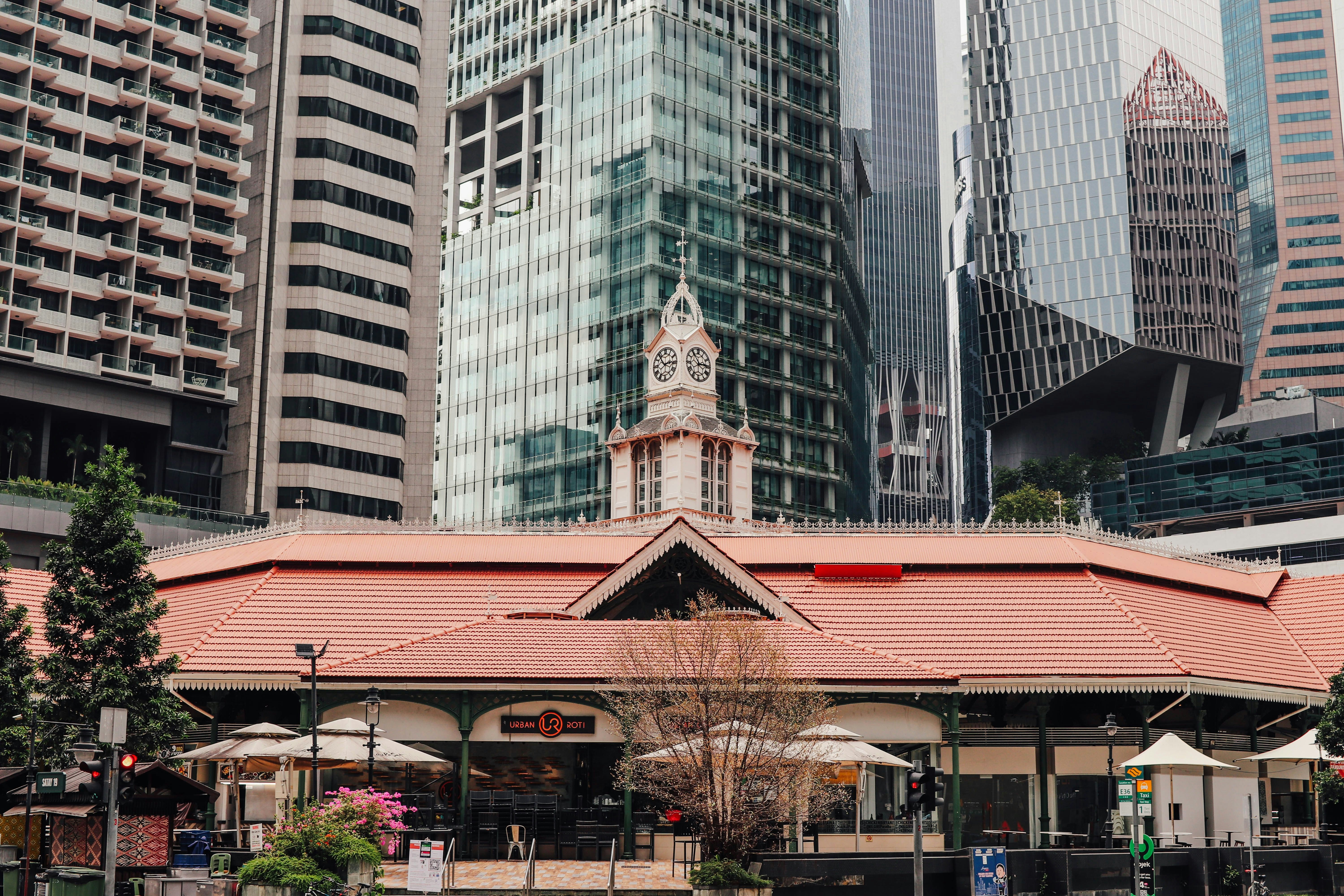 a building with a clock tower in the middle of a city, Lau Pa Sat Market in the day. Photo by SGXP.com