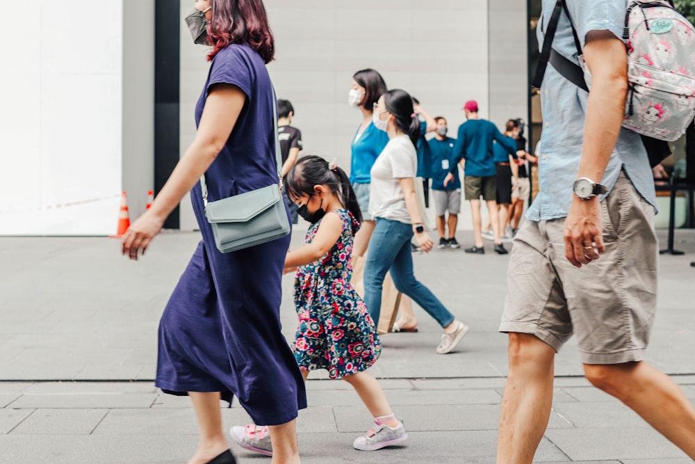 a group of people walking down a street