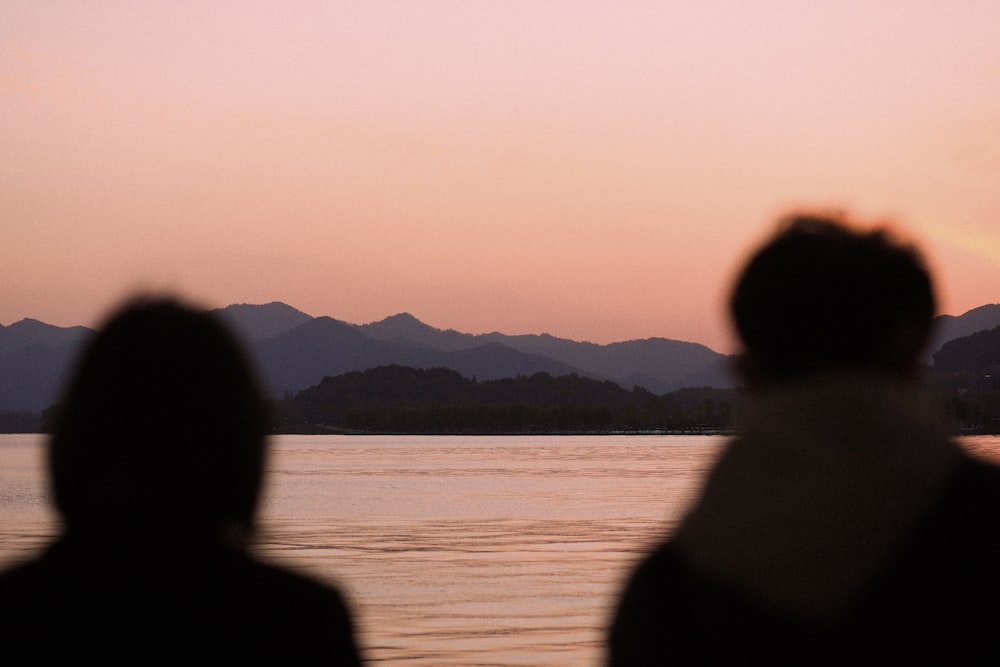 a couple of people that are looking at the water