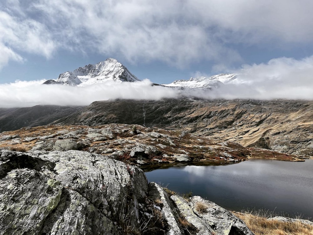 a view of a mountain with a lake in the foreground