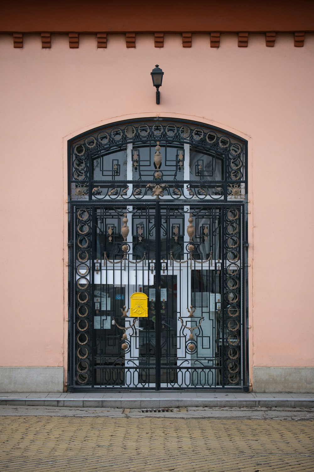a black gate with a yellow sign on it