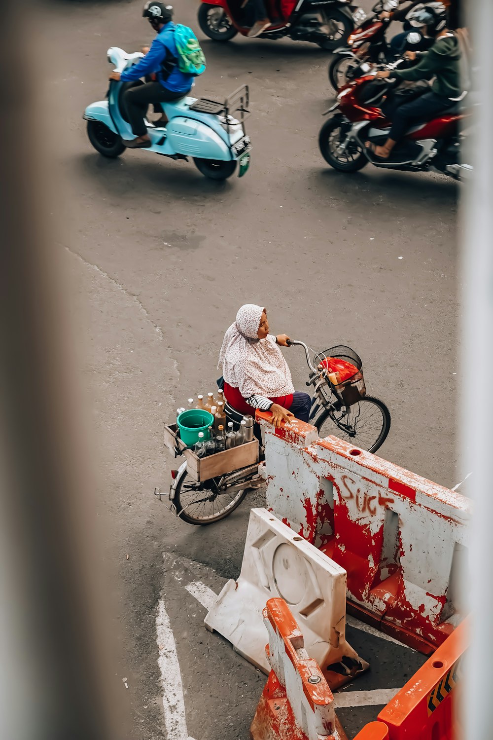 a man riding a motorcycle down a street