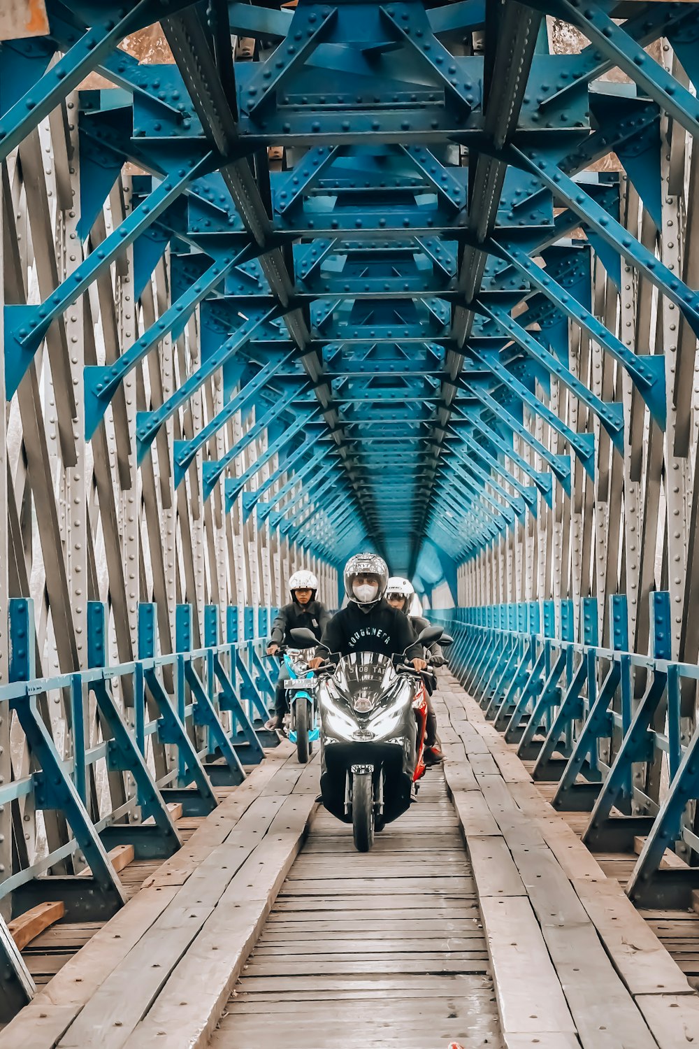 a man riding a motorcycle on a bridge