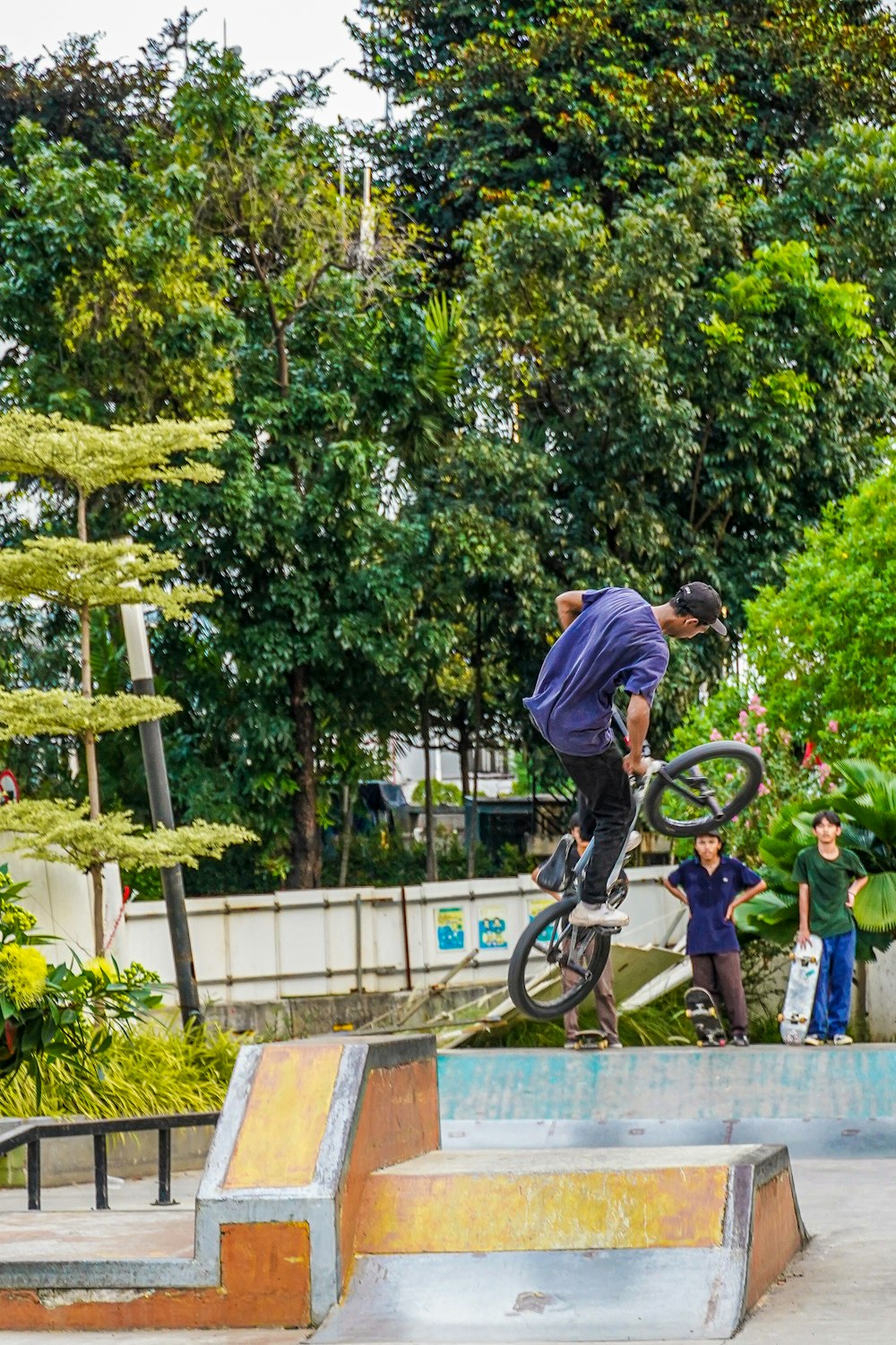 a man riding a bike up the side of a ramp