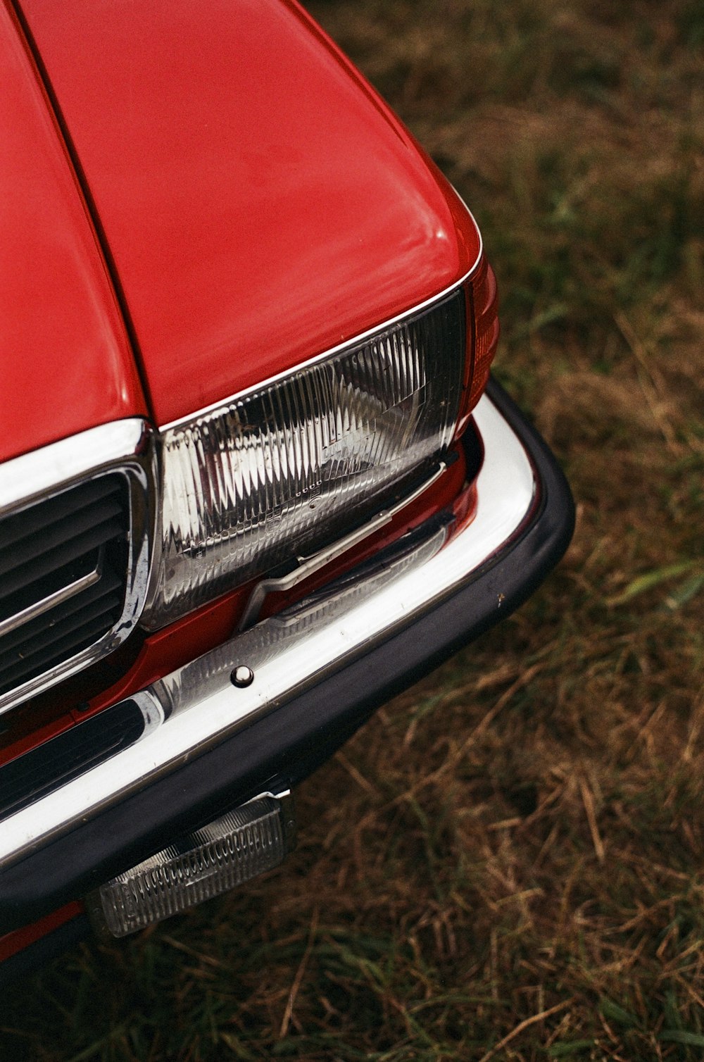 a close up of the front end of a red car