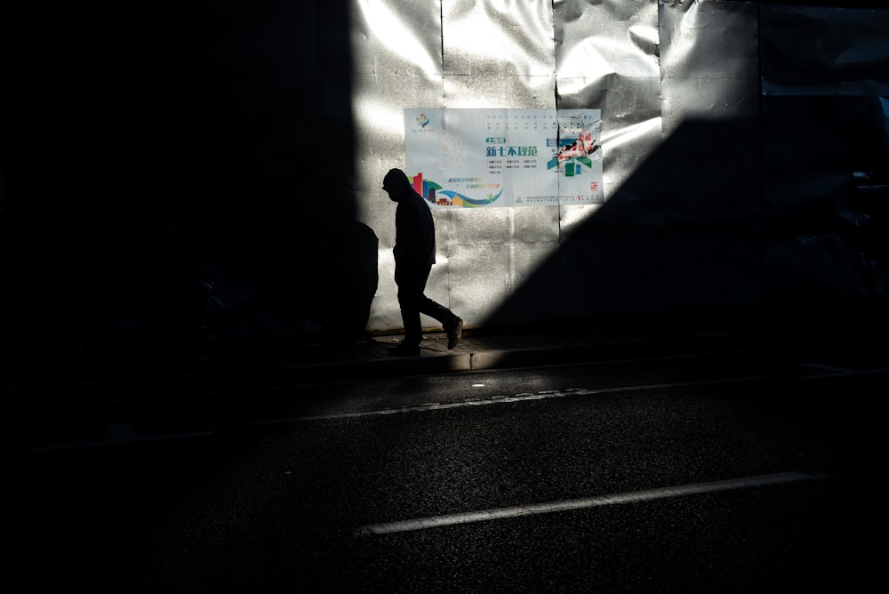 a person walking down a street in the dark