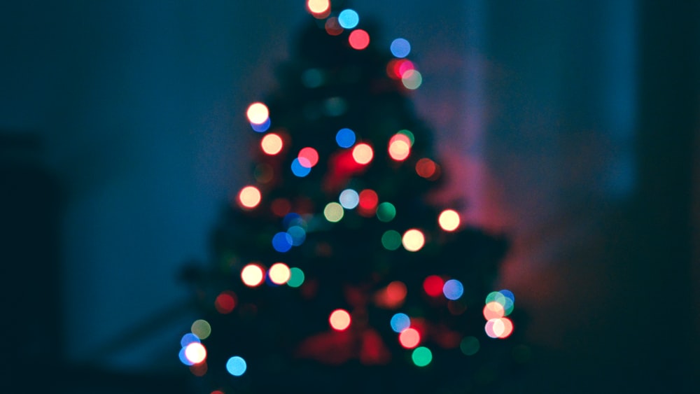 a lit christmas tree in a dark room