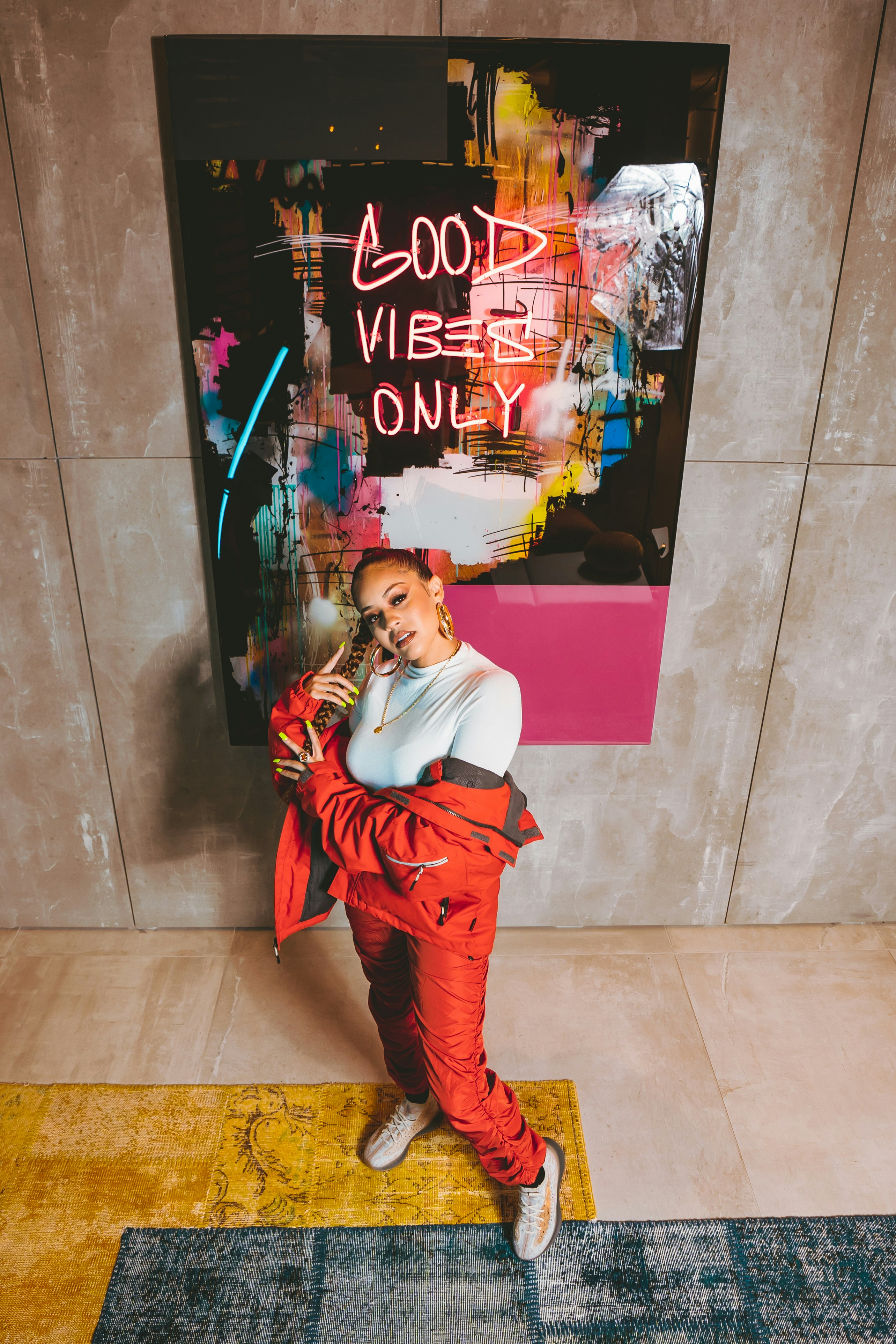 A woman standing in front of a painting on a wall photo – Free Human ...