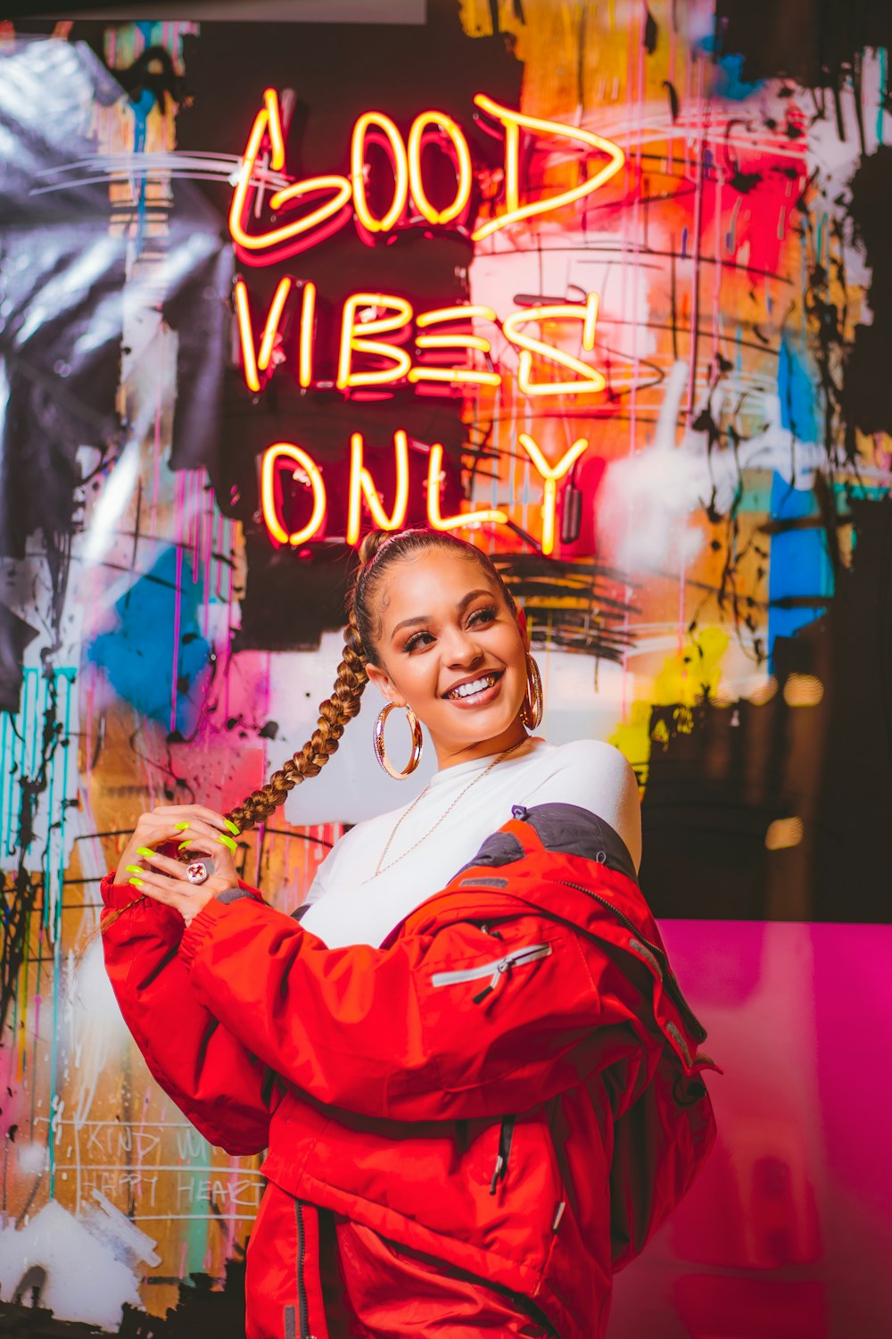 a woman standing in front of a neon sign