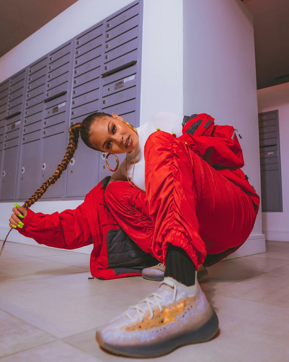 a woman in a red outfit sitting on the floor