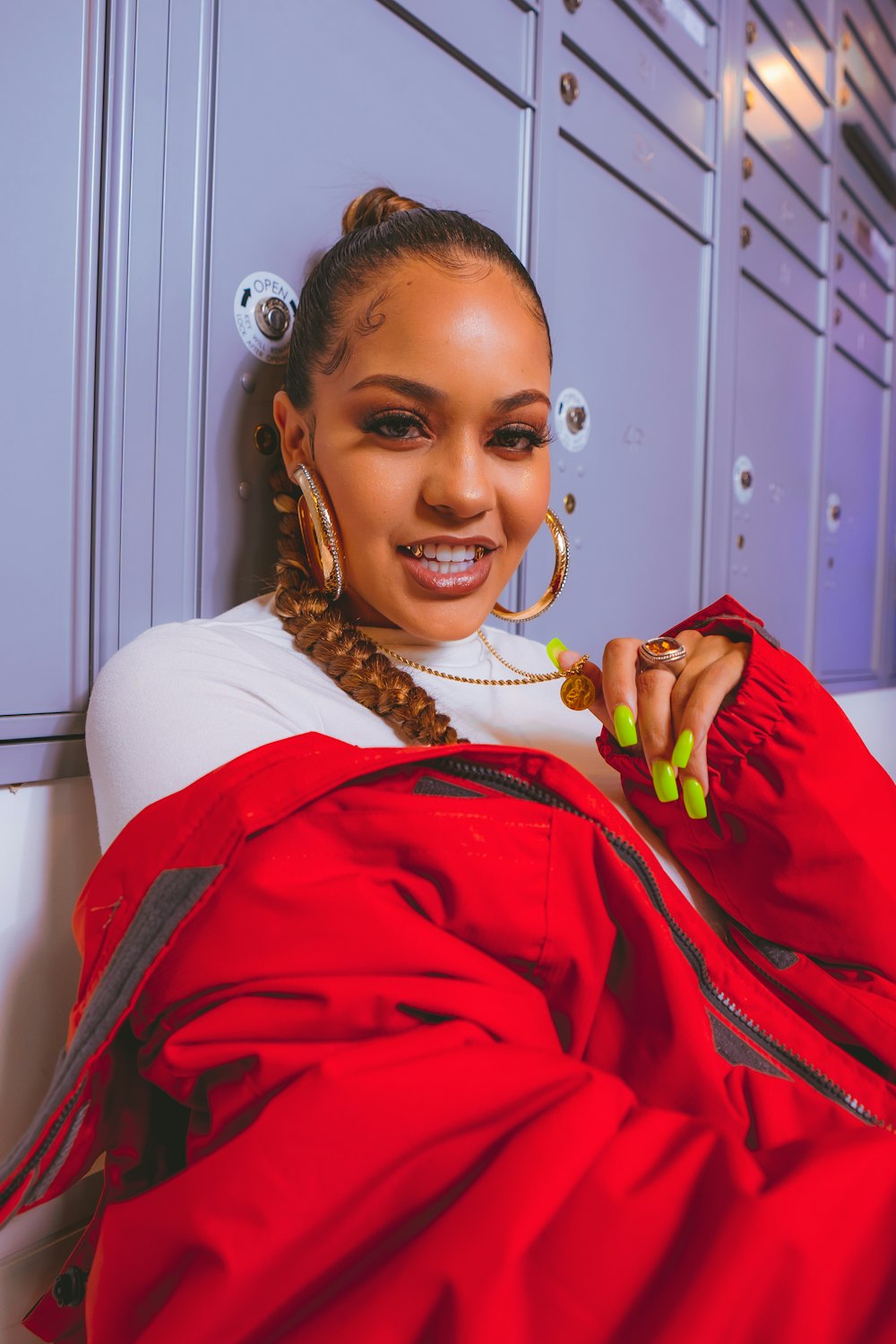 a woman in a red jacket is smiling