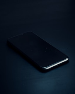 a close up of a cell phone on a table