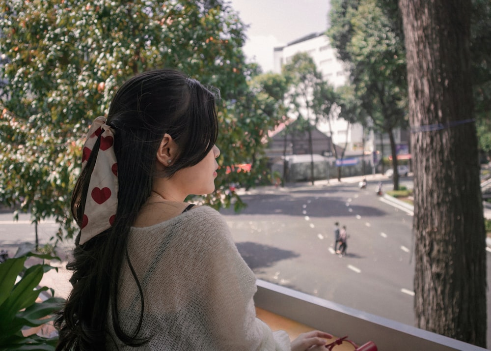 a woman looking out a window at a street