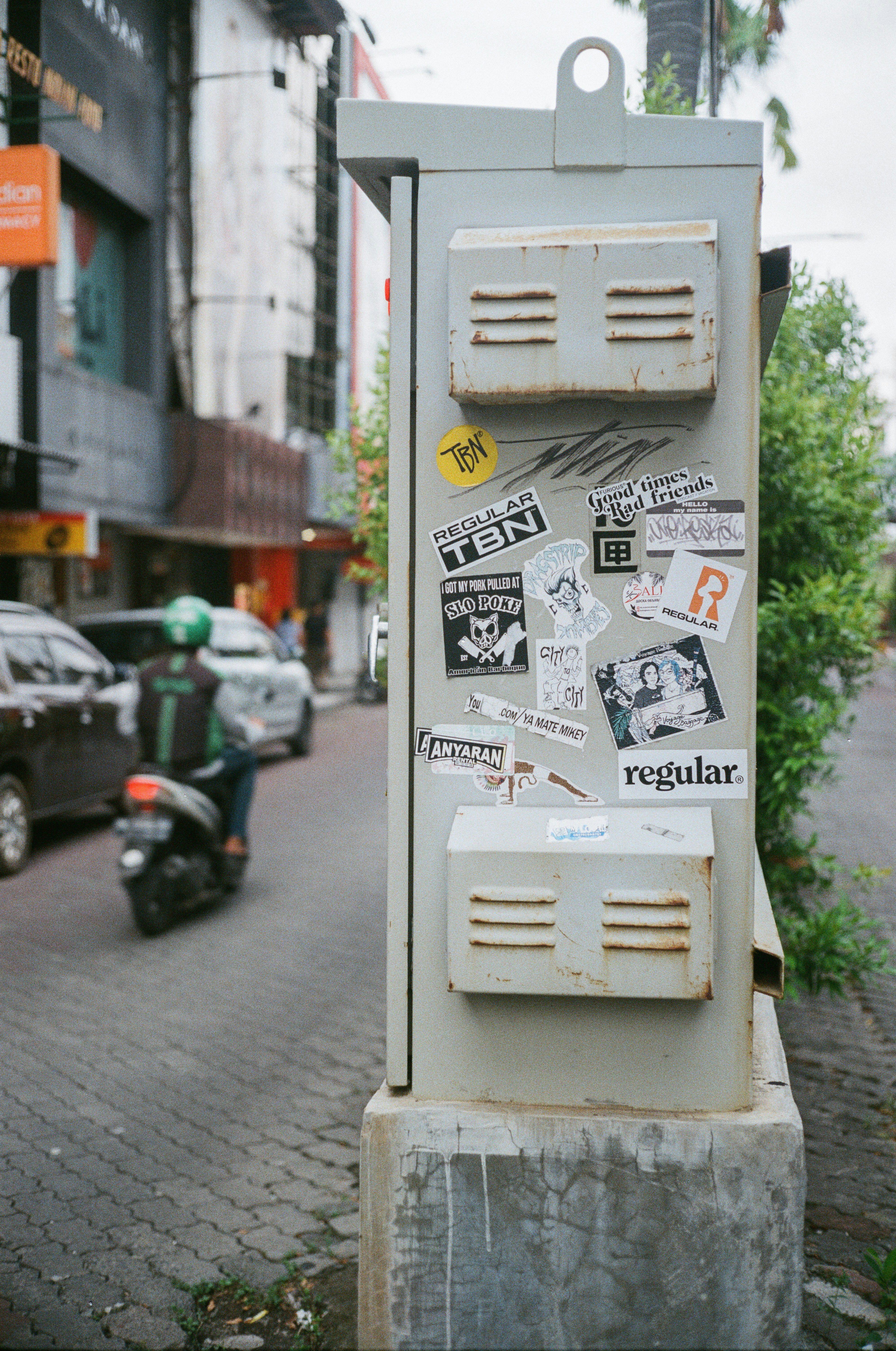 a street scene with focus on a telephone