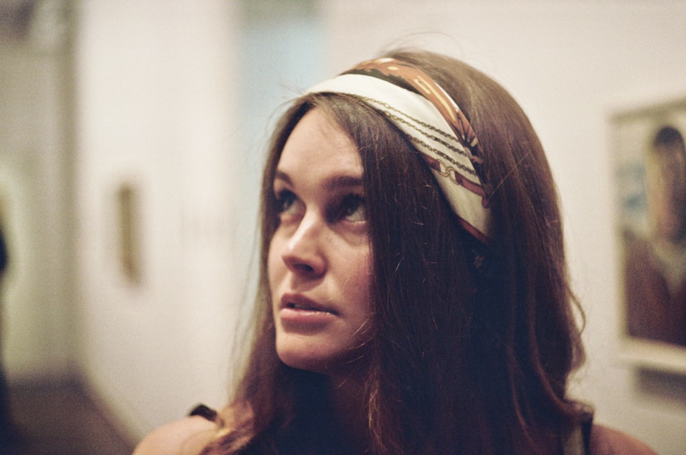 a woman with long hair wearing a headband