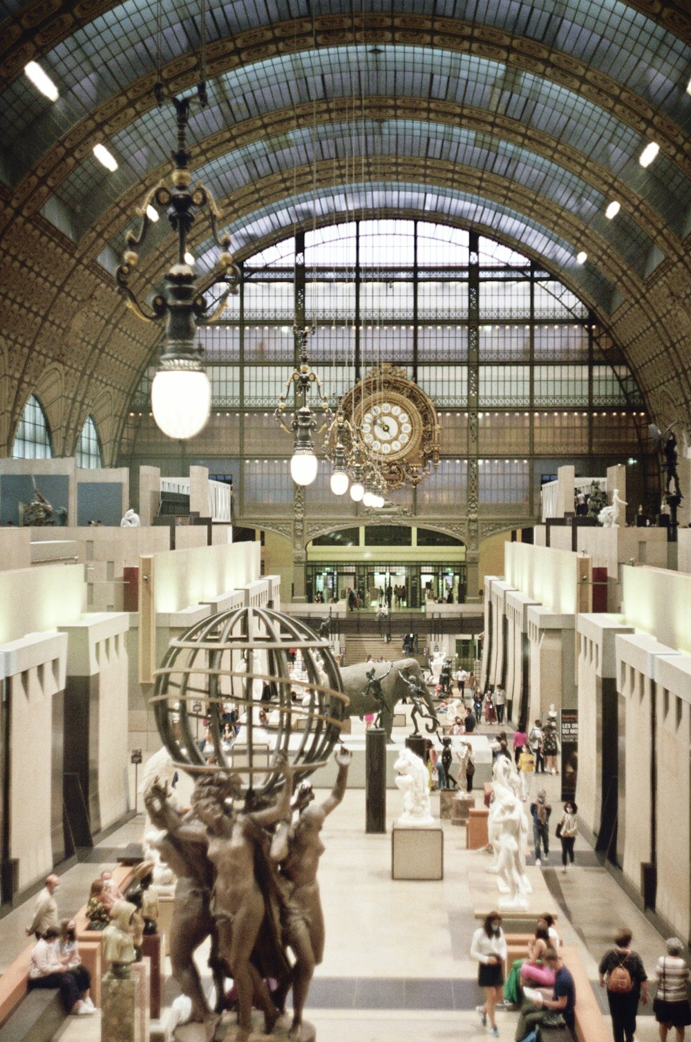 a large building with a statue of a man holding a globe