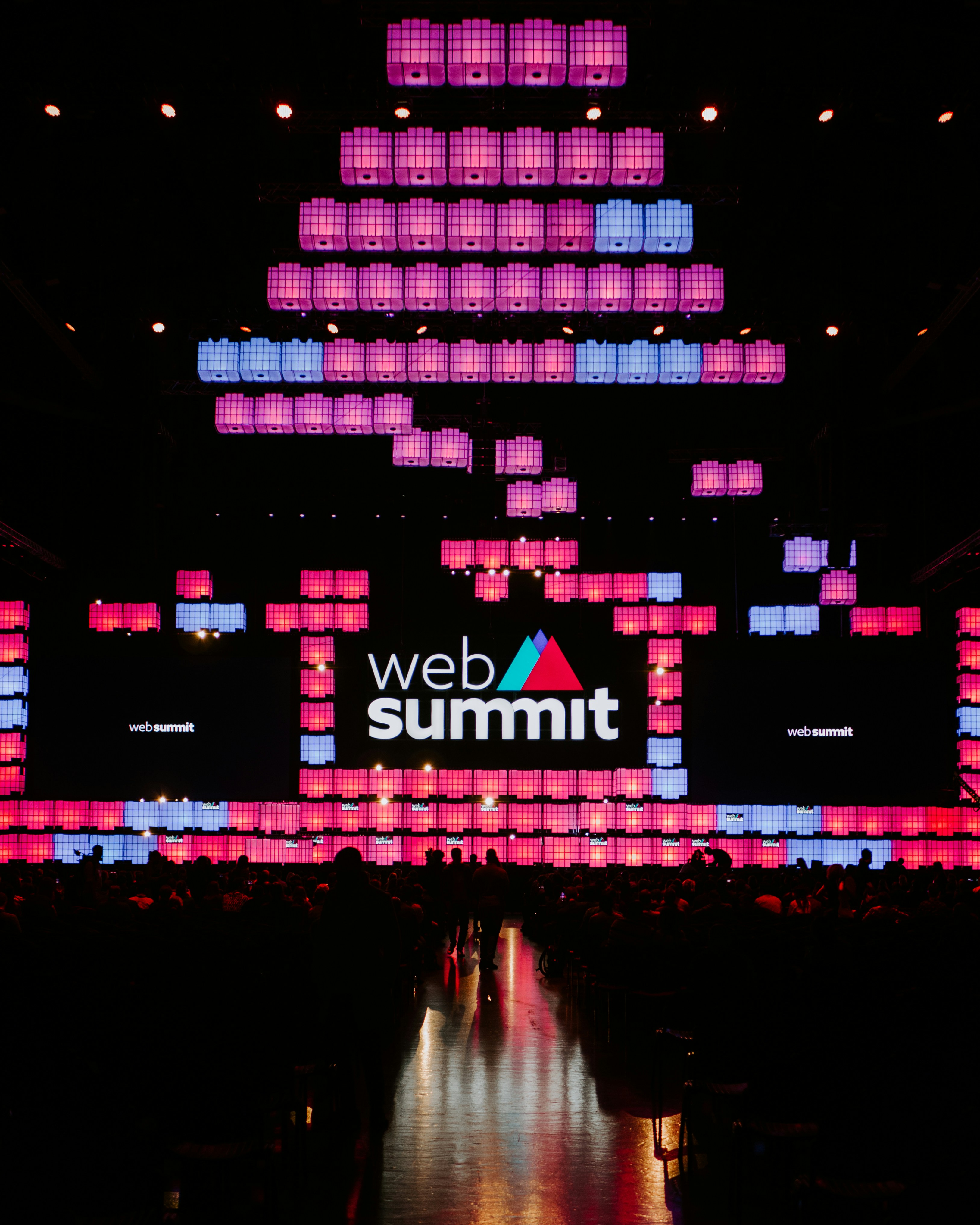 Startup conference stage with large crowd and colorful lighting at Slush Helsinki