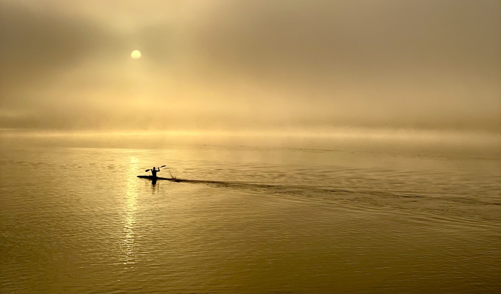 a person on a surfboard in the middle of a body of water