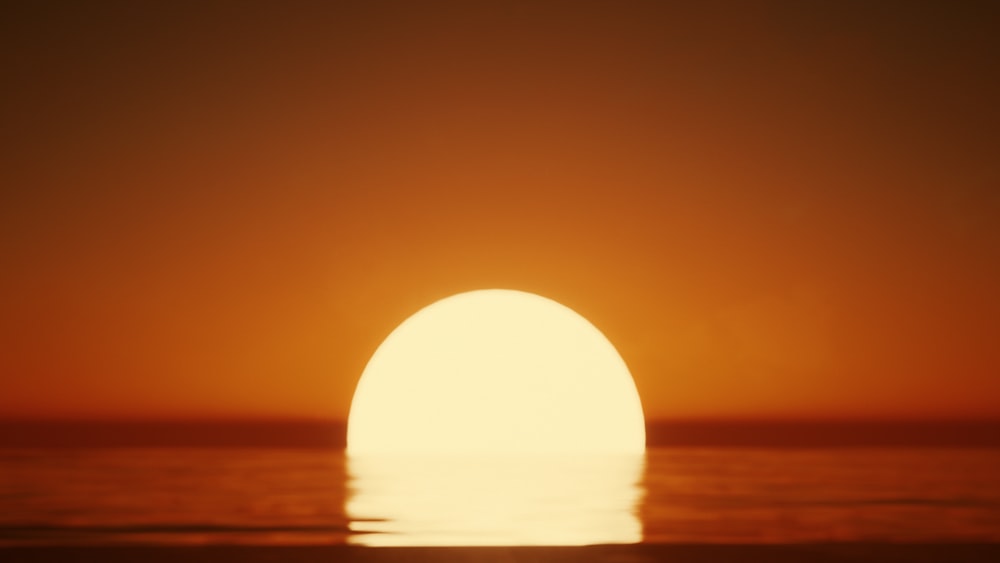 the sun is setting over the ocean on a clear day