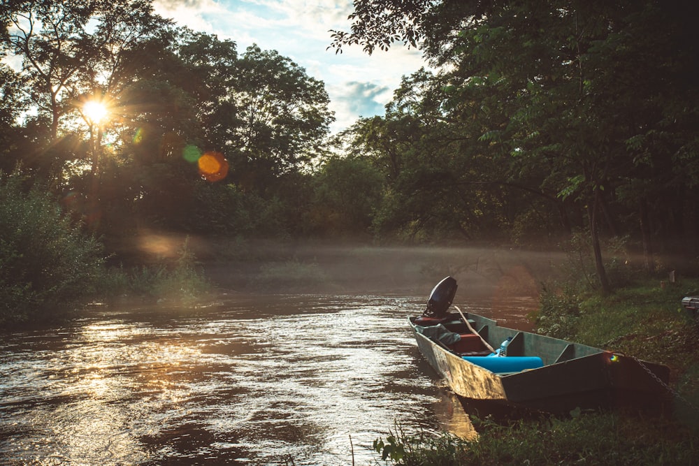 a canoe is sitting on the bank of a river