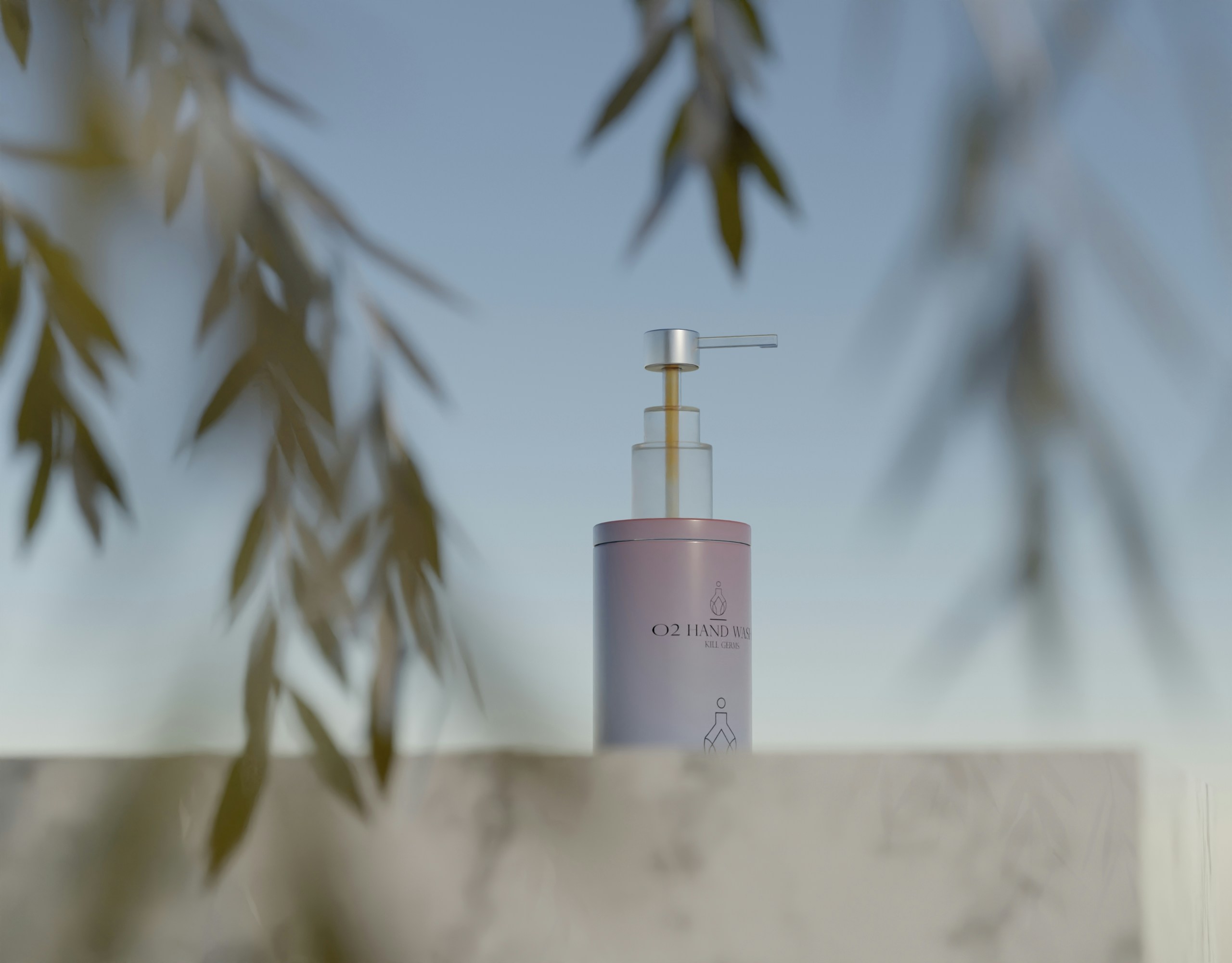 a bottle of liquid sitting on top of a white wall