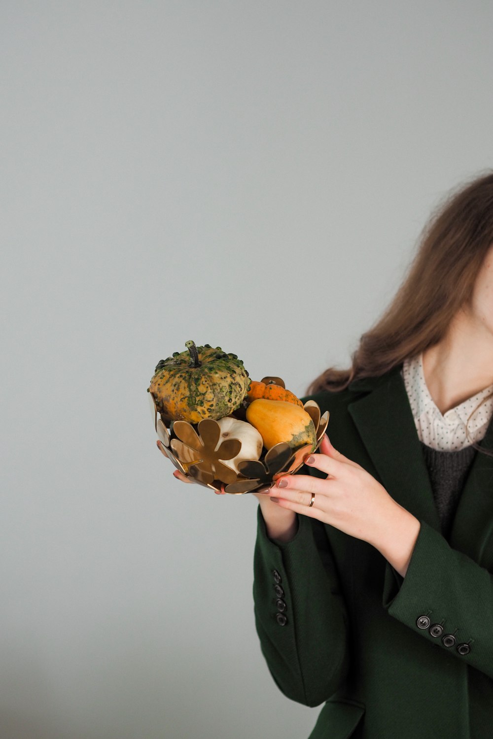 a woman holding a bunch of fruit in her hands