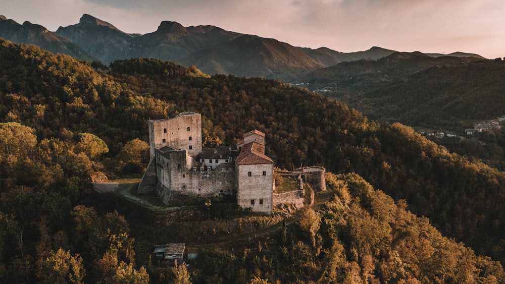 an aerial view of a castle in the mountains