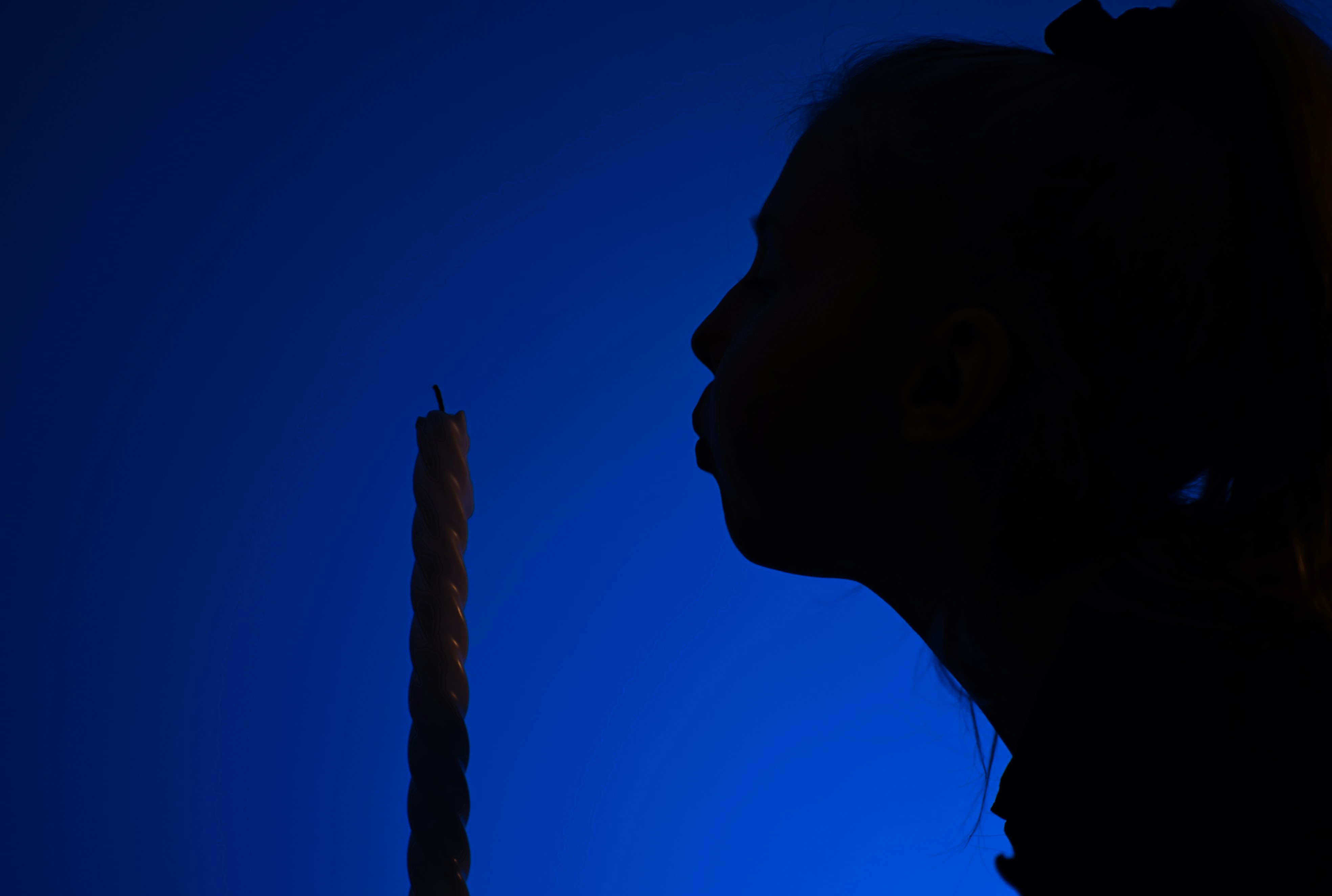 Silhouette of a young girl that just blew out a candle