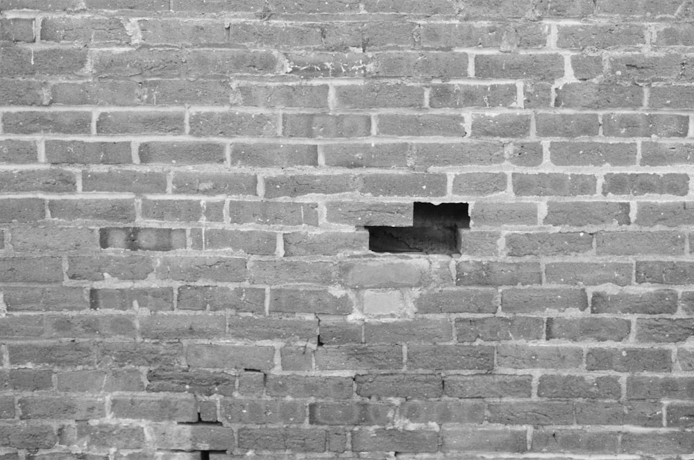 a black and white photo of a brick wall