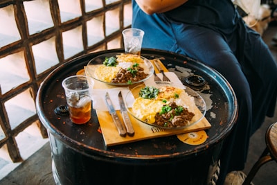 a person sitting at a table with food on it