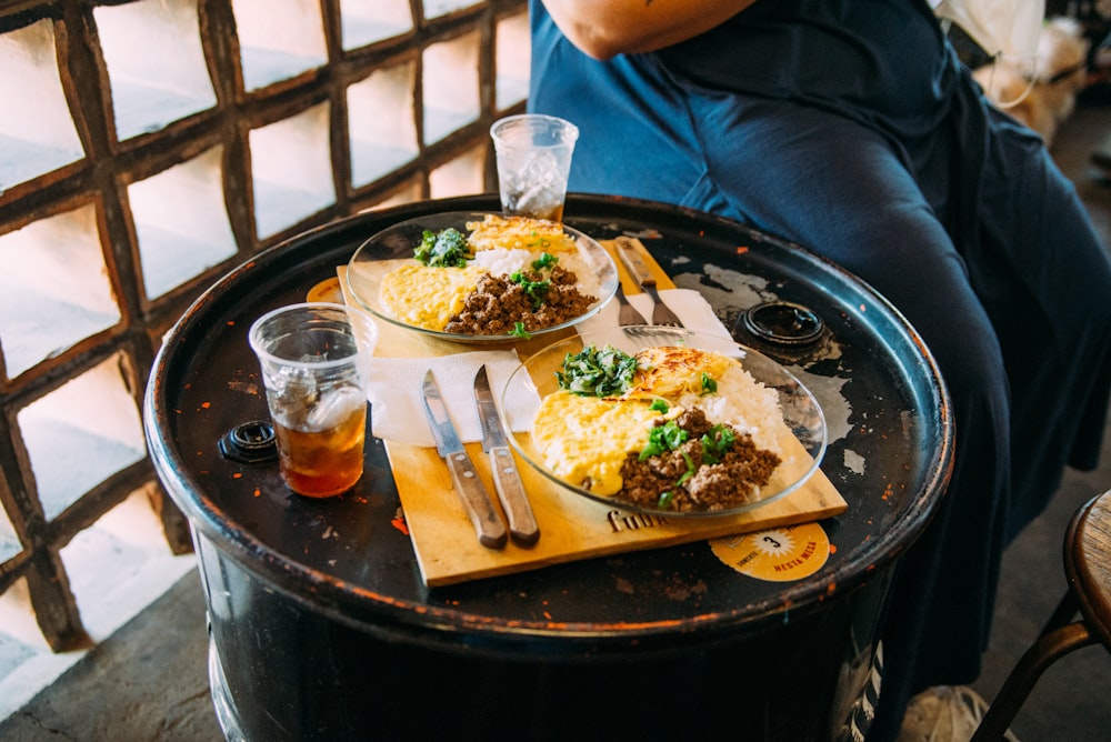 a person sitting at a table with food on it